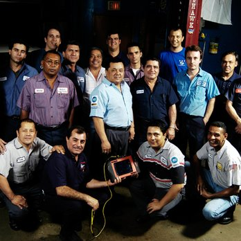 Group of automotive technicians in the shop with a professional scan tool during class