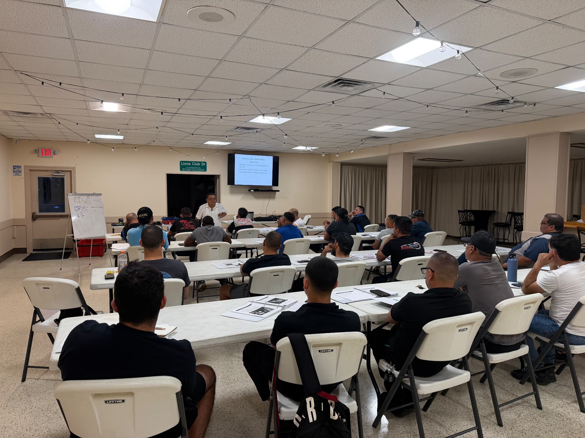 Wide view of a packed evening ASE prep class in Miami Springs